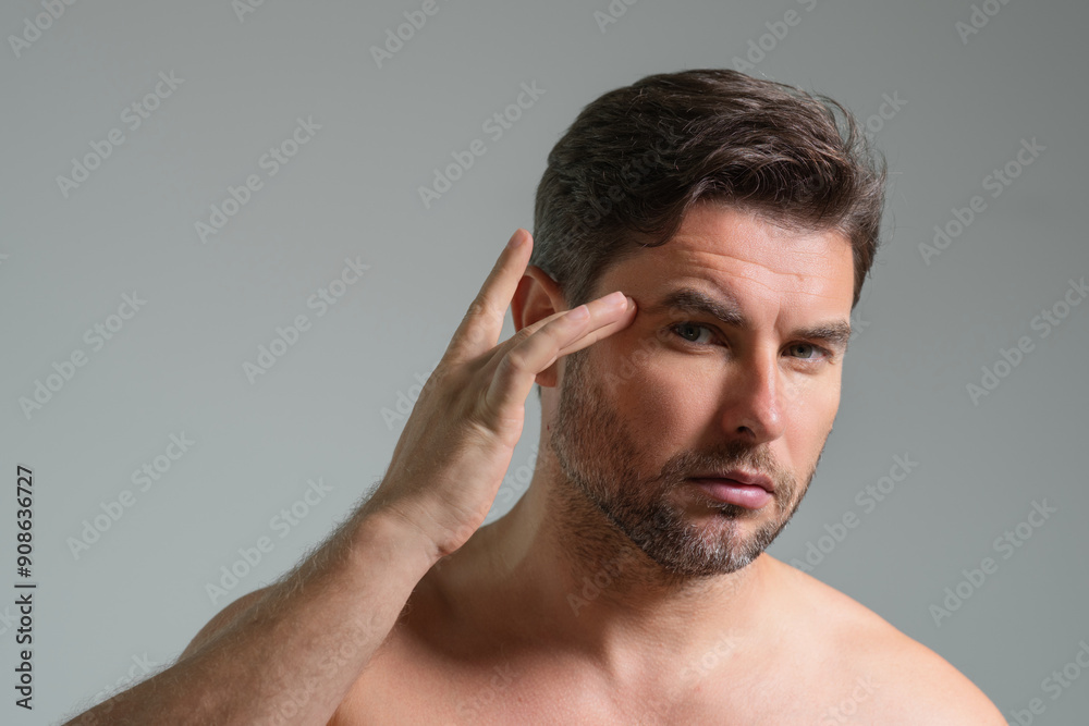Obraz premium Millennial hispanic man touch skin, facial skin and stubble. Male beauty care product. Skin care, home spa. Beauty portrait of a beautiful man. Spa model, moisturizing nourishing skin creme.