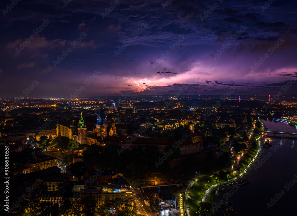 Fototapeta premium Thunderstorm over the Wawel Royal Castle in Krakow. Panorama of the city of Krakow. Night. Poland, Europe. Aerial photos from a drone.