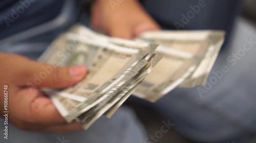 Indian Rupee banknotes on hands, Indian rupee (INR) is official currency in India and subdivided. Businesswomen's hands counting money for paying shopping goods services
