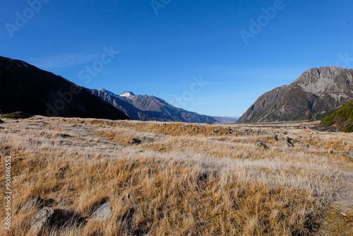 Hiking in a beautiful sunny blue sky winter day at Mount Cook national park, Otago, Canterbury, South Island New Zealand