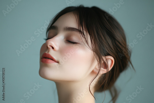 A close up of a girl's face with her eyes closed