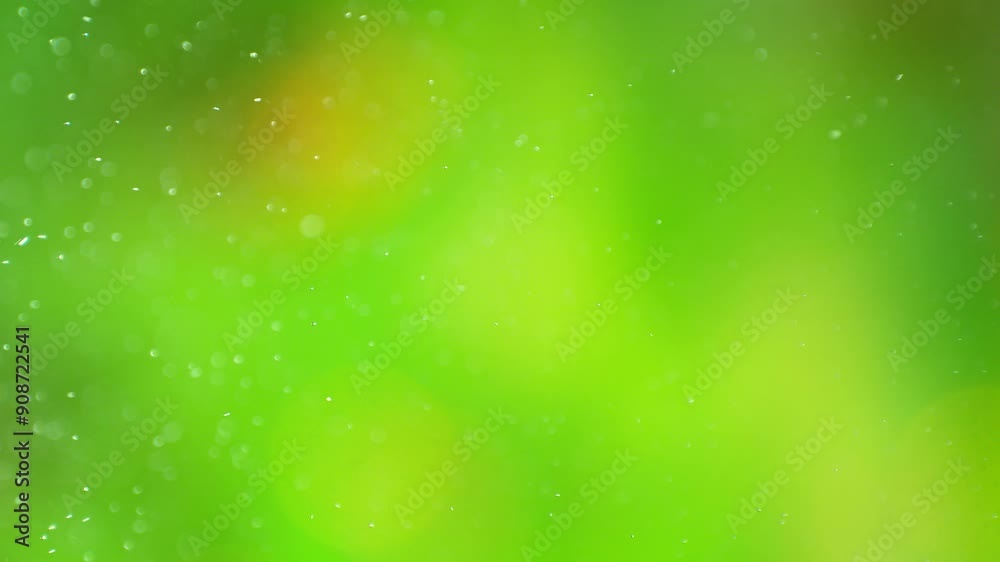 Super Slow Motion Shot of Dewing on Abstract Bokeh Fresh Green Background at 1000fps. Super Slow Motion Shot of Dewing on Abstract Bokeh Fresh Green Background at 1000fps.