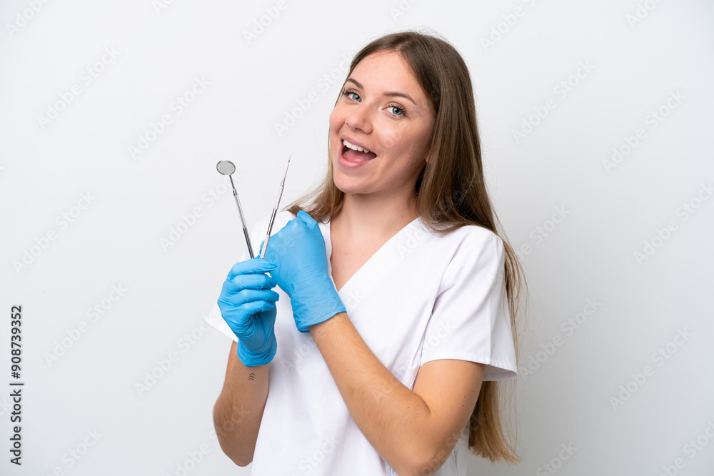 Dentist woman holding tools isolated on white background celebrating a victory Dentist woman holding tools isolated on white background celebrating a victory