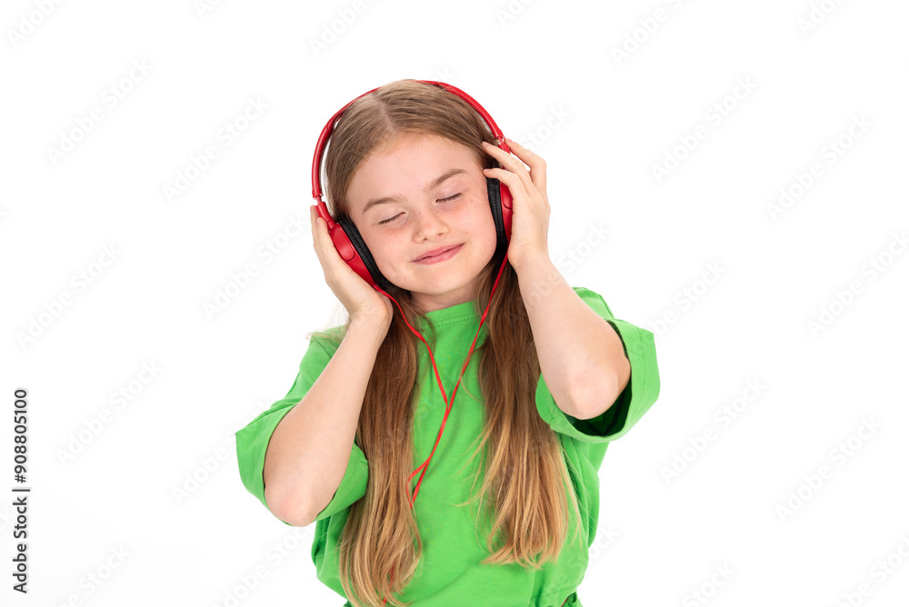 Happy girl in green summer outfit dancing enjoying music in red headphones on white background Happy girl in green summer outfit dancing enjoying music in red headphones on white background