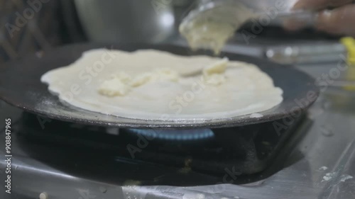 Patishapta Pitha, a famous Bengali Dessert Recipe, being prepared during Winter season. Patishapta is a type of pithe made in celebratory occasions, quick Indian dessert. Howrah, West Bengal, India photo