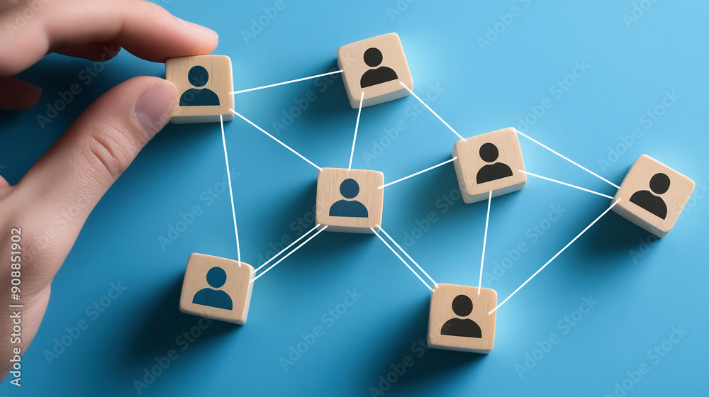 Hand Connecting People With Wooden Blocks On Blue Background, Representing Network, Business Team, And Digital Community.
Hand Connecting People With Wooden Blocks On Blue Background, Representing Network, Business Team, And Digital Community.