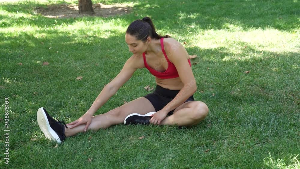 A woman is doing stretching and exercising outdoors in a park, focusing on fitness and wellness A woman is doing stretching and exercising outdoors in a park, focusing on fitness and wellness