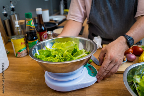 Chef at the kitchen preparing spicy glass noodle salad photo