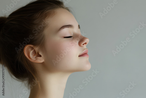 A close up of a girl's face with her eyes closed