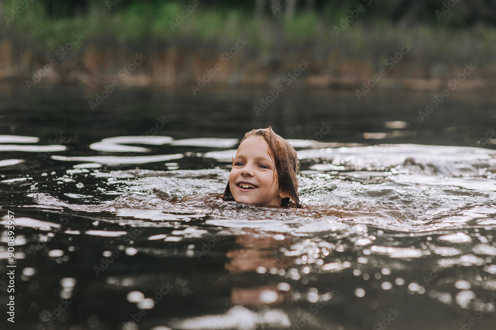 Fototapeta premium Happy girl, smiling child swims in water on sea, lake. Photography, portrait, lifestyle.