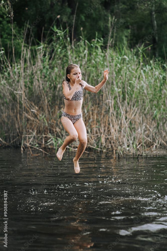 Athletic beautiful teenage girl, child jumping from a wooden bridge, pier into the water on a lake outdoors in nature in the summer on vacation. Photography, portrait, childhood concept, sport. Athletic beautiful teenage girl, child jumping from a wooden bridge, pier into the water on a lake outdoors in nature in the summer on vacation. Photography, portrait, childhood concept, sport.