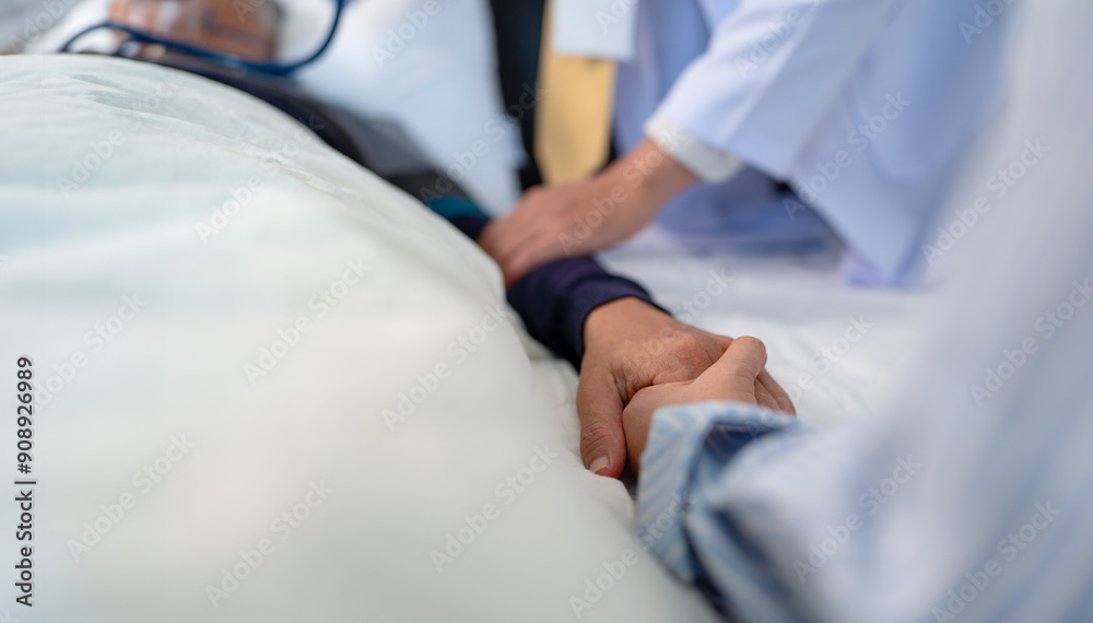 scene of bedridden patient, focus on hand of illness's relative holding hands elderly hopeless senior male with infectious disease, concept of nursing home care or medical treatment in hospital ward scene of bedridden patient, focus on hand of illness's relative holding hands elderly hopeless senior male with infectious disease, concept of nursing home care or medical treatment in hospital ward