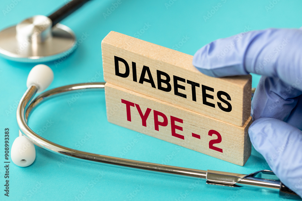 Diabetes type 2. Medical and health concept. Diabetes type 2 symbol, words on wooden blocks, stethoscope, doctor hand, Beautiful blue background
