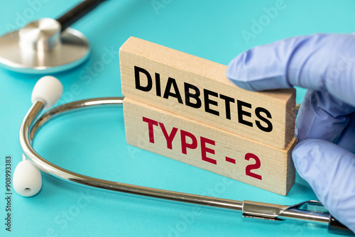 Obraz na płótnie Diabetes type 2. Medical and health concept. Diabetes type 2 symbol, words on wooden blocks, stethoscope, doctor hand, Beautiful blue background w salonie