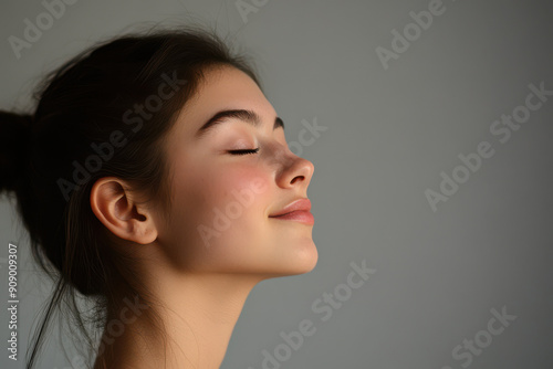 A close up of a girl's face with her eyes closed