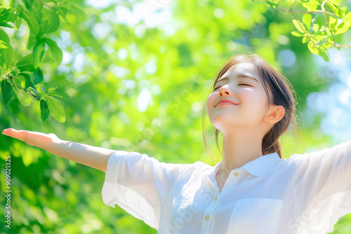 woman nature in a park, with a beautiful sunlight and green trees in the background. feeling happy while relaxing outdoors on a summer day, with a smiling face expression of relaxation and happiness