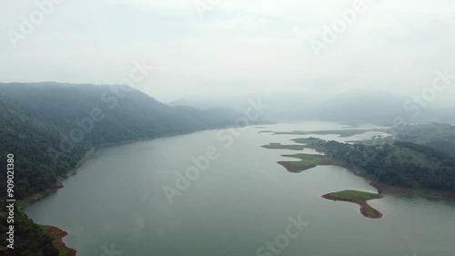 Aerial view of umiam lake serene blue water with misty mountains aerial image is taken at umiam lake shillong meghalaya india. it is showing the breathtaking beauty of nature. photo