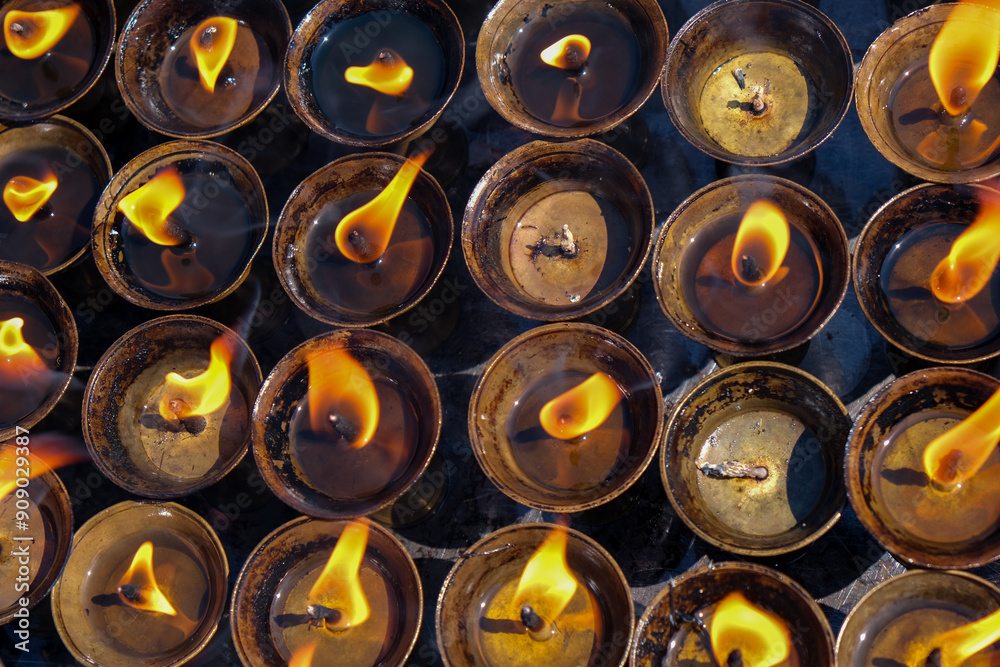Religious candles glowing win a hindu temple. Symbols of faith religion and for wishes and prayers Religious candles glowing win a hindu temple. Symbols of faith religion and for wishes and prayers