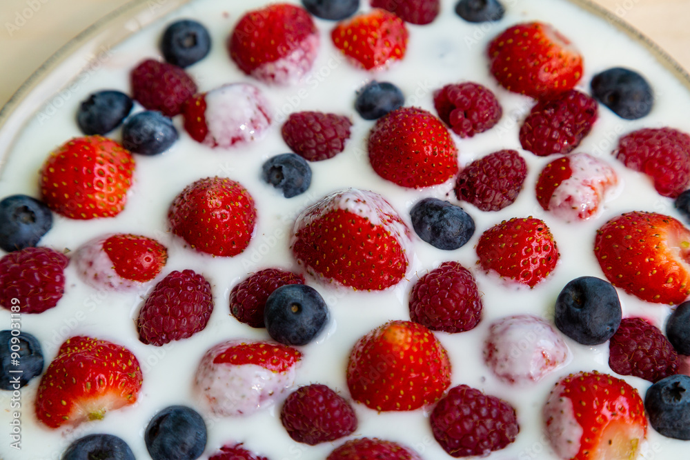 In a plate with whipped cream, fresh berries strawberries, raspberries and blueberries In a plate with whipped cream, fresh berries strawberries, raspberries and blueberries