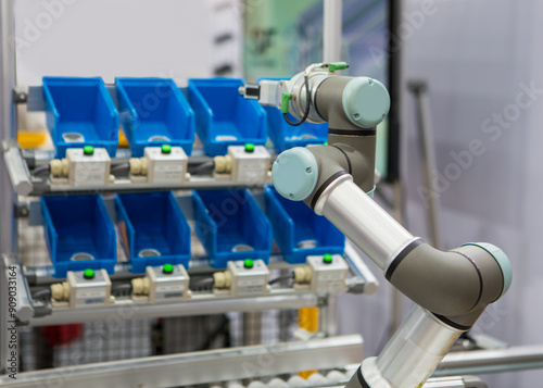 Smart warehouse. Robots pick up parts from plastic bin rack. 