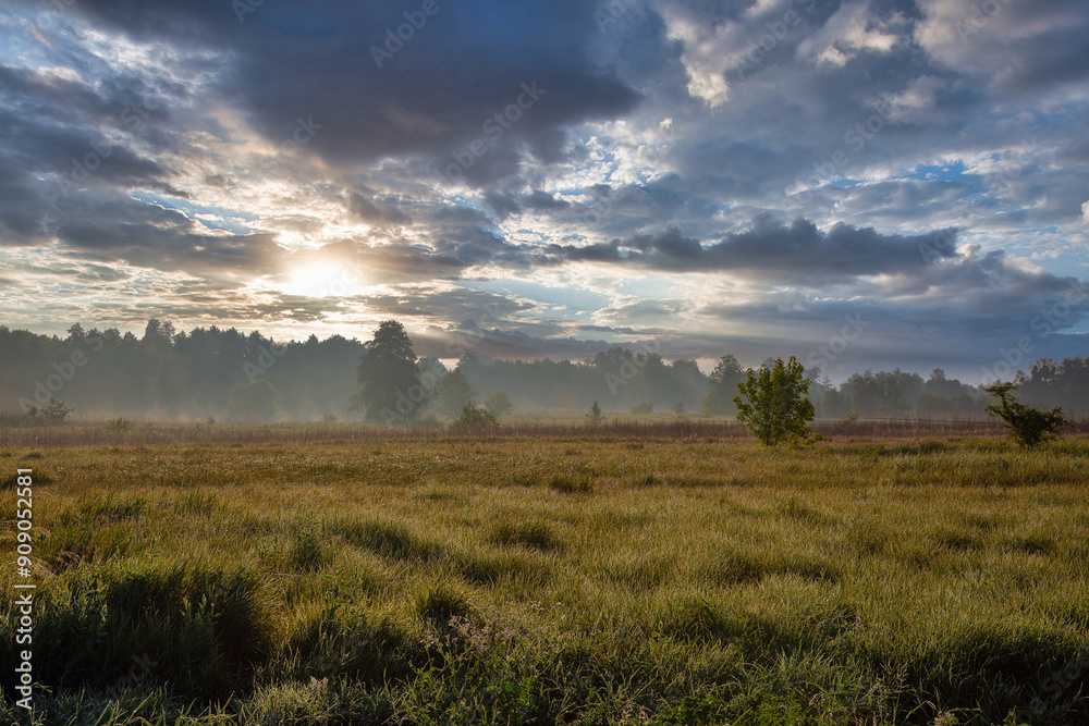 Summer early morning landscape with haze over river. Dramatic sky. Summer early morning landscape with haze over river. Dramatic sky.