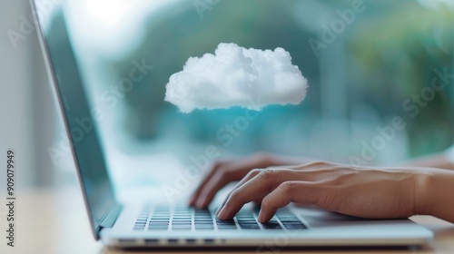 Hands typing on a laptop, digital cloud overlay photo