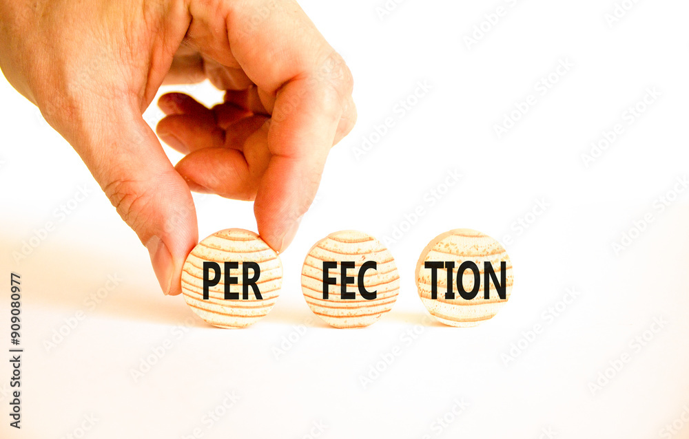 Perfection symbol. Concept word Perfection on beautiful wooden circles. Beautiful white table white background. Businessman hand. Business perfection concept. Copy space. Perfection symbol. Concept word Perfection on beautiful wooden circles. Beautiful white table white background. Businessman hand. Business perfection concept. Copy space.