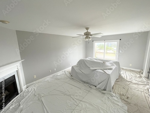 Canvas Print Living room space covered with painter's drop cloths with a freshly painted ceiling