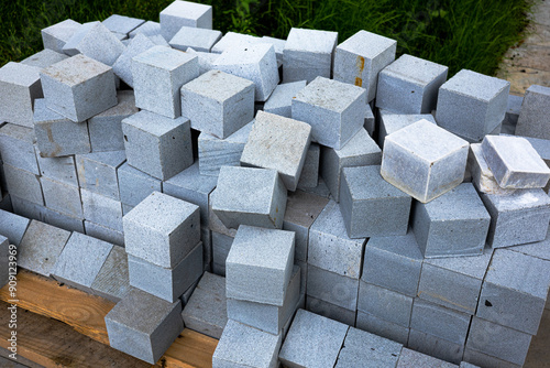 Gray cubic paving slabs piled outside 