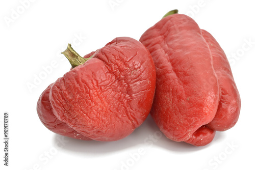 Two bell peppers with wrinkled skin. Damaged by high temperature.