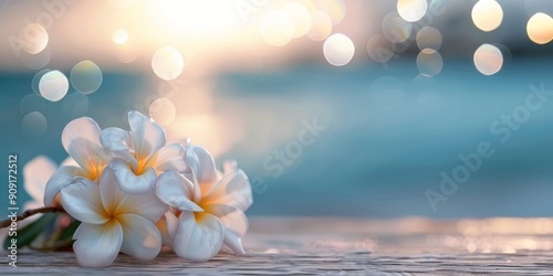 Delicate Frangipani Flowers on a Seaside Wooden Table at Sunset