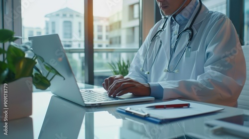 The doctor typing on laptop photo