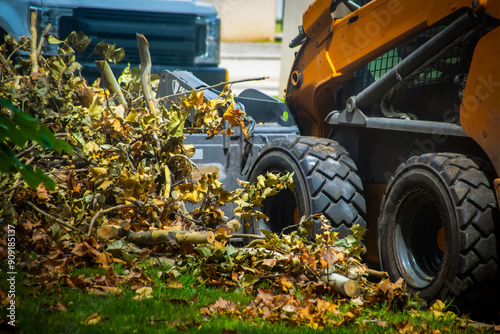 Front Loader Cleaning Up Limbs and Leaves After Storm