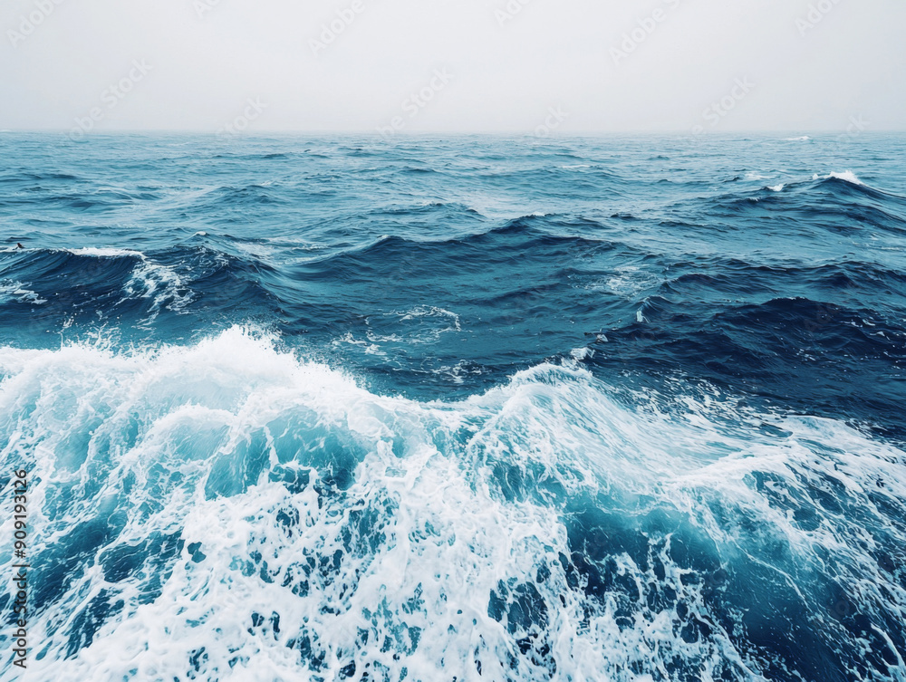 Fototapeta premium The ocean is calm and peaceful, with only a few waves breaking on the shore