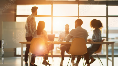 A productive meeting with diverse individuals collaborating and brainstorming in a bright  modern office space during sunset.