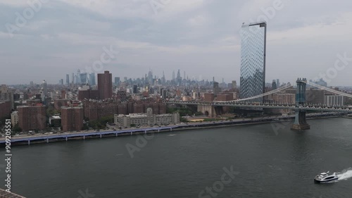 Aerial push in shot from Brooklyn,over Brooklyn bridge to Manhattan on a cloudy day