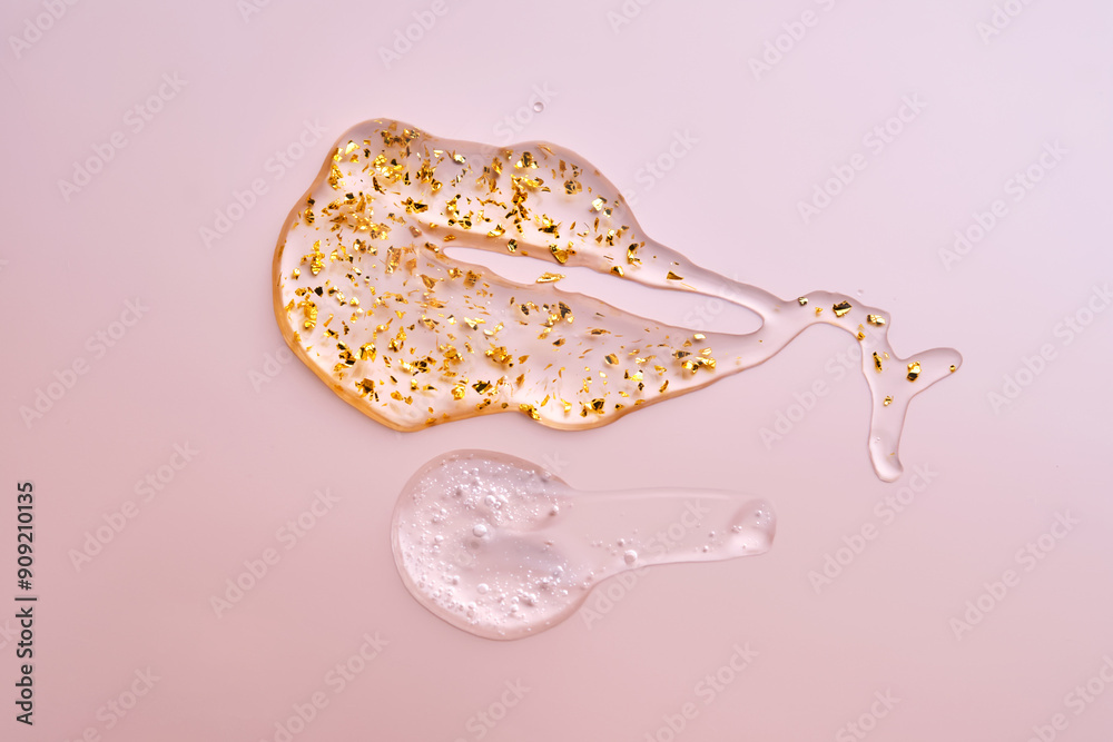 Fototapeta premium Texture of face serum and serum with 24k gold on a pink background.
