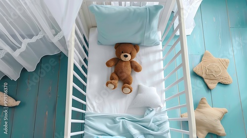 Top view of crib with canopy sheets cushion and teddy bear