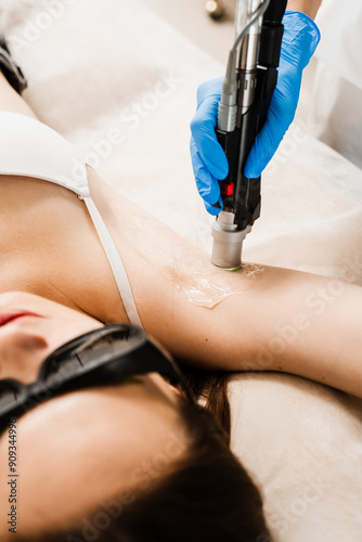 Painless laser epilation removal of hair underarms. Girl is having a laser procedure to get rid of armpit hair for a long time for sensitive skin. Destroying hair follicles for a long-last effect.