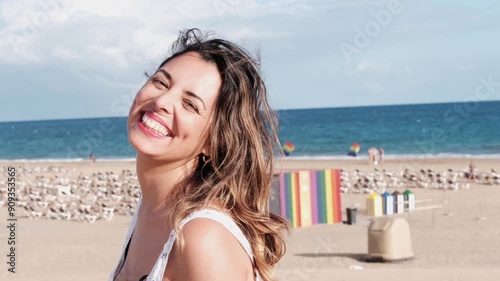 Woman looking at camera smiling showing happiness on a day at the beach. 4k video
