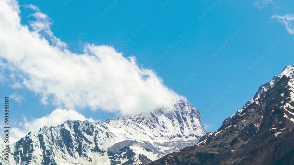 4K Timelapse shot of clouds above the snowy Himalayan mountain peaks as seen from Marbal village in Lahaul and Spiti district, Himachal Pradesh, India. Clouds move above the snowy Himalayas in summer. 4K Timelapse shot of clouds above the snowy Himalayan mountain peaks as seen from Marbal village in Lahaul and Spiti district, Himachal Pradesh, India. Clouds move above the snowy Himalayas in summer.