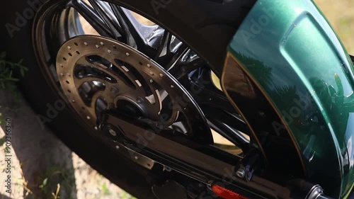 Tread on black tire on motorcycle wheel close up movie slow motion. Tire fitting concept photo