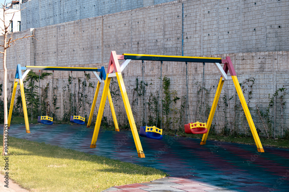 Colorful children's playground with empty swings Colorful children's playground with empty swings