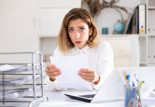 Tired businesswoman working with documents in office at the table photo