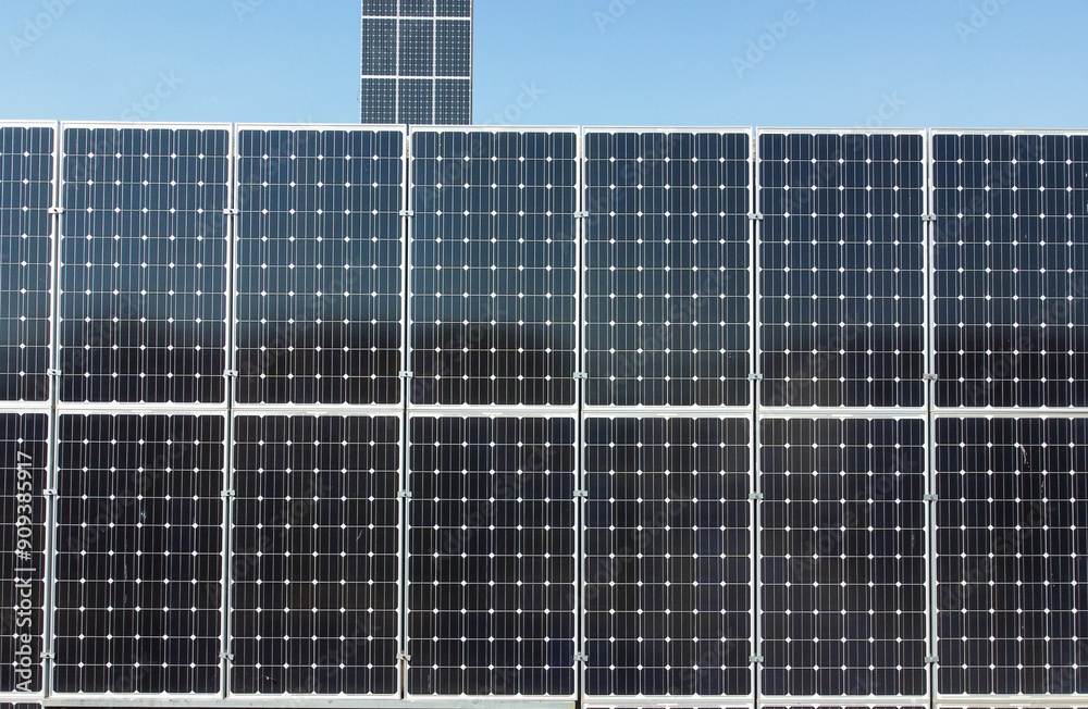 Solar cell plant. Aerial drone view of solar panels at the top of a building. Producing clean renewable energy from the sun. Photovoltaic solar cells. Producing Electric energy. Solar cell plant. Aerial drone view of solar panels at the top of a building. Producing clean renewable energy from the sun. Photovoltaic solar cells. Producing Electric energy.