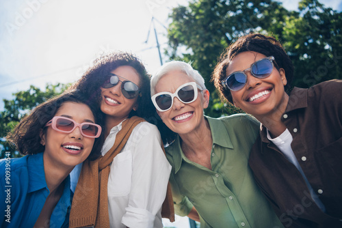 Photo of company friends women toothy smile good mood free time chill walk city park outdoors