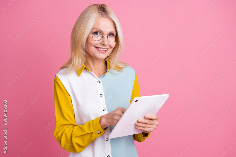 Portrait of elegant aged lady tablet empty space wear shirt isolated on pink color background Portrait of elegant aged lady tablet empty space wear shirt isolated on pink color background