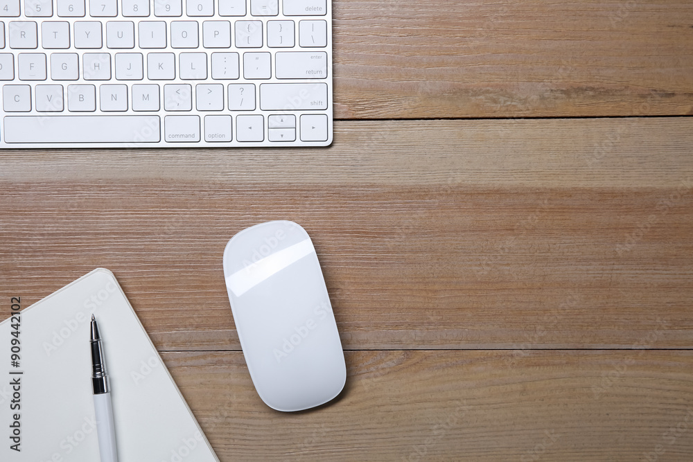 Fotografie Wireless mouse, notebook, pen and computer keyboard on wooden table, flat lay