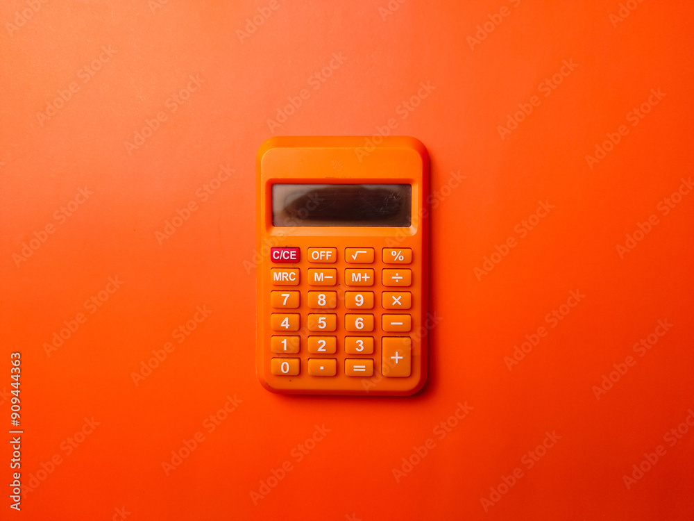 Top view orange calculator on a orange background
