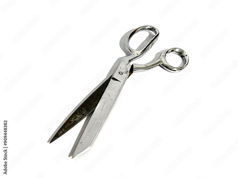 A single tailor cloth fabric scissors made from metal for sewing isolated on white background A single tailor cloth fabric scissors made from metal for sewing isolated on white background